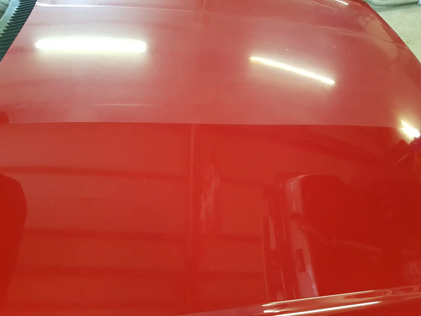 Polished red paintwork reflecting light